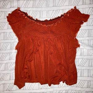 Off shoulder orange top.
